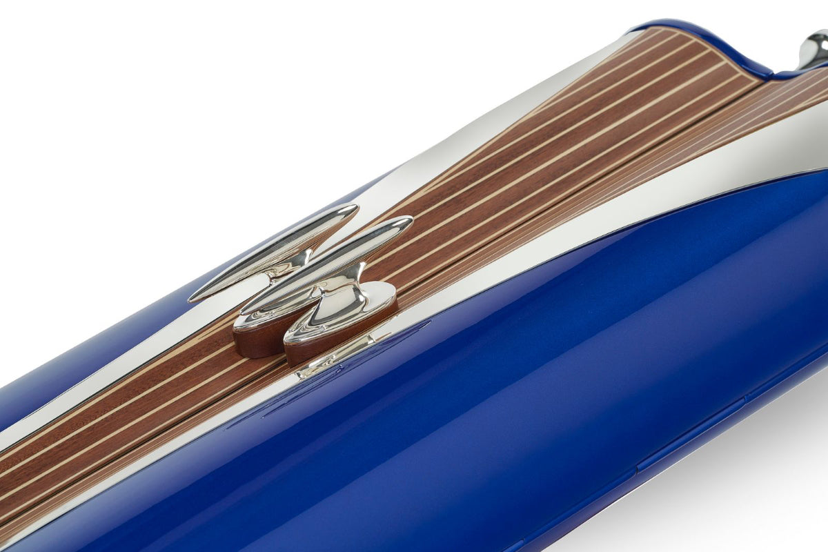 Close-up of a blue and silver torah
 with wooden accents on a white background